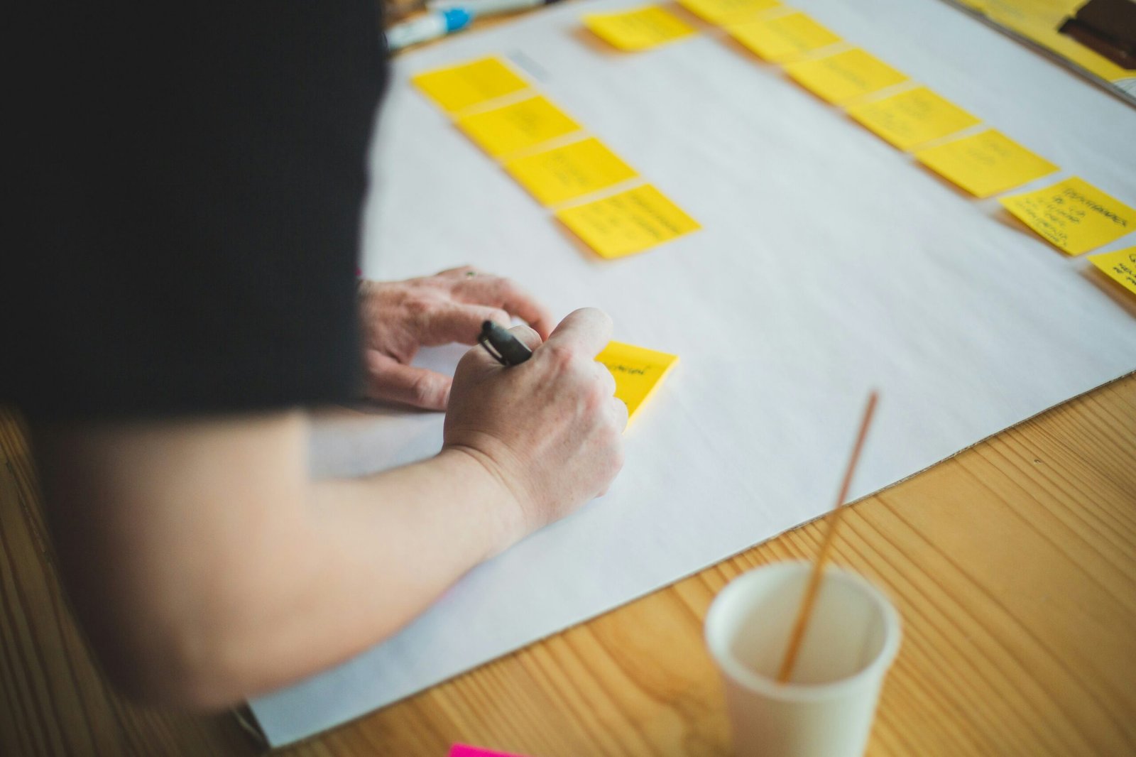employee writing employer branding terms on sticky notes