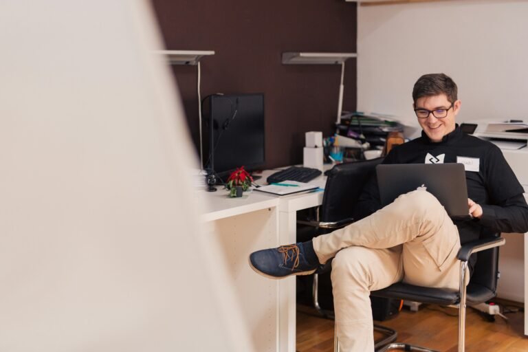 Passive candidate sitting in a relaxed way with laptop on his lap
