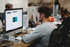 Employee in front of laptop working on Personalization in Recruitment Marketing