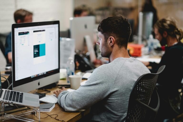 Employee in front of laptop working on Personalization in Recruitment Marketing
