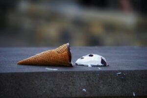 An ice cream and cone that dropped on the floor to illustrate employer branding mistakes